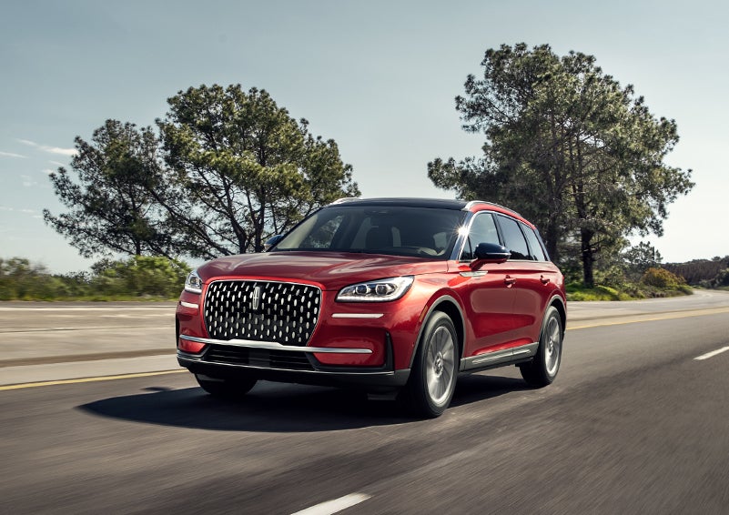 A 2024 Lincoln Corsair® SUV is shown being driven on a country road. | Hooks Lincoln in Fort Worth TX