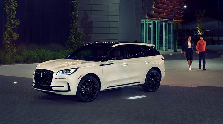 Two people approach a 2024 Lincoln Corsair® SUV featuring the available Jet Appearance Package. | Hooks Lincoln in Fort Worth TX