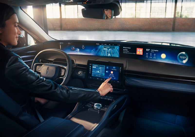 The driver of a 2024 Lincoln Nautilus® SUV interacts with the center touchscreen. | Hooks Lincoln in Fort Worth TX