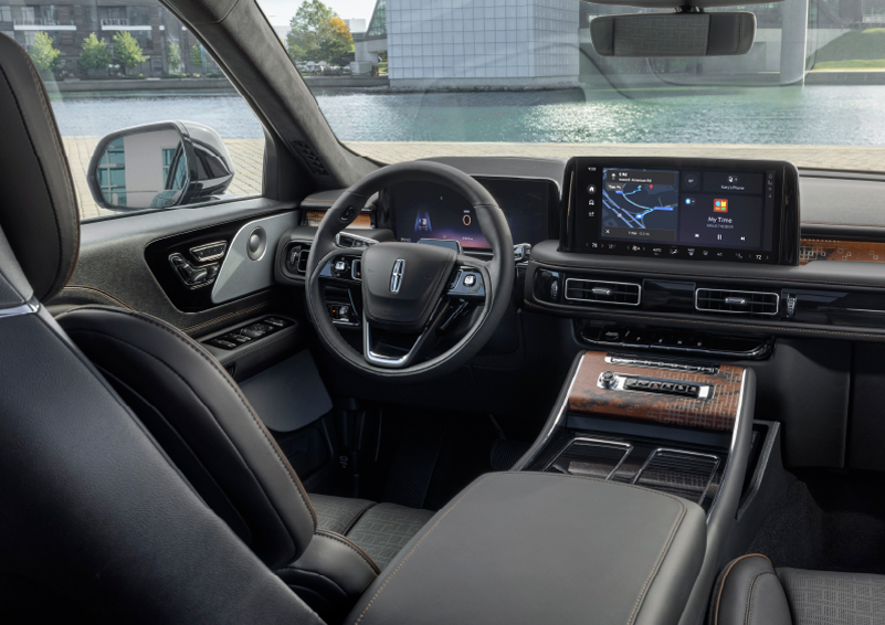 The interior of the 2025 Lincoln Aviator® SUV is shown parked with a view of a harbor through the windshield. | Hooks Lincoln in Fort Worth TX