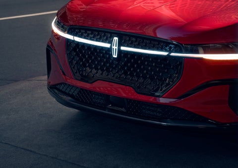 The available front LED light bar and center Lincoln Star logo glow at dusk. | Hooks Lincoln in Fort Worth TX