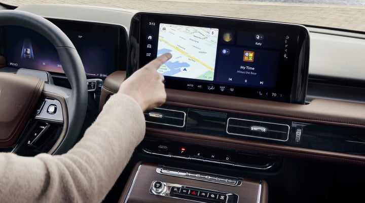 A person is tapping the center display touchscreen of a 2026 Lincoln Aviator® SUV. | Hooks Lincoln in Fort Worth TX