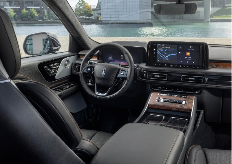The interior of the 2026 Lincoln Aviator® SUV is shown parked with a view of a harbor through the windshield. | Hooks Lincoln in Fort Worth TX