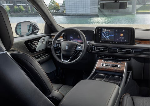 The interior of the 2026 Lincoln Aviator® SUV is shown parked with a view of a harbor through the windshield. | Hooks Lincoln in Fort Worth TX