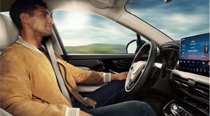 A person is shown using Lincoln BlueCruise hands-free highway driving technology on a divided highway in a hands-free Blue Zone. | Hooks Lincoln in Fort Worth TX
