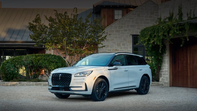 A 2026 Lincoln Corsair® SUV is parked in front off a luxury home. | Hooks Lincoln in Fort Worth TX