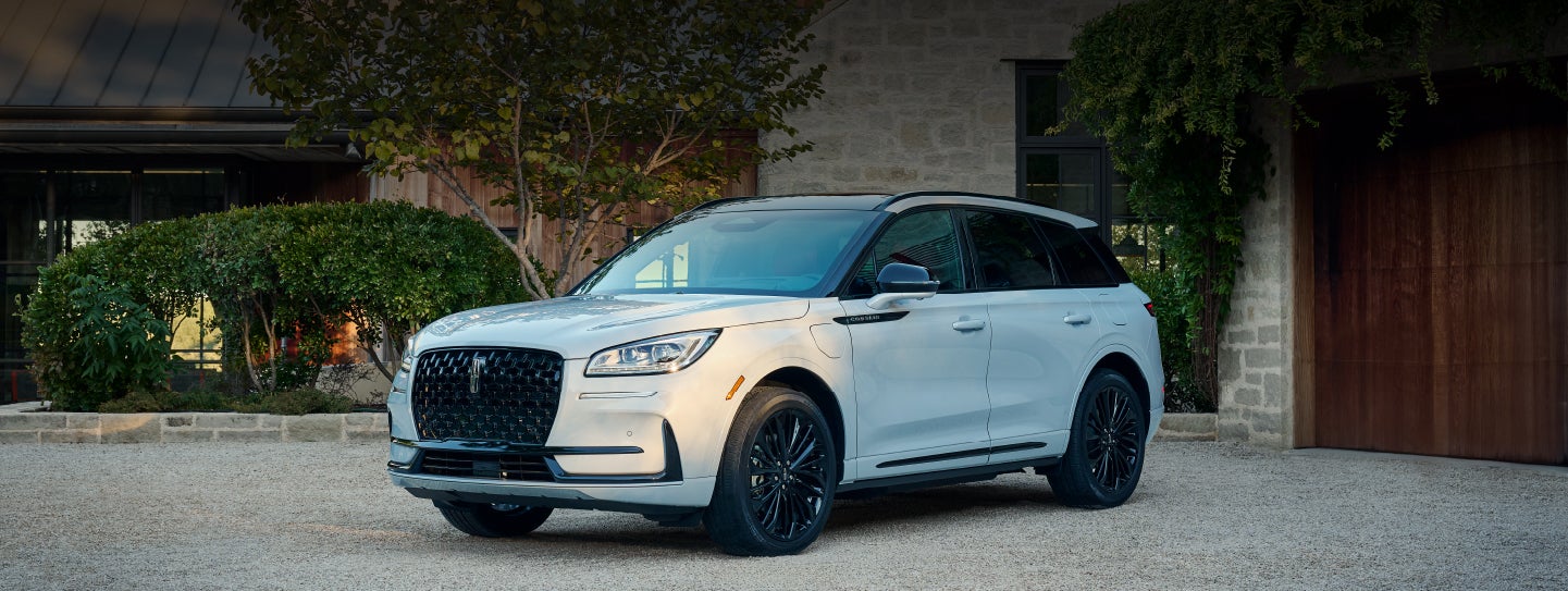 A 2026 Lincoln Corsair® SUV is parked in front off a luxury home. | Hooks Lincoln in Fort Worth TX
