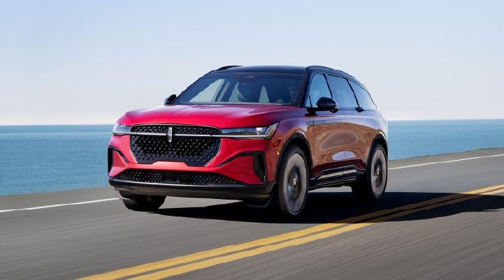 A 2026 Lincoln Nautilus® SUV is being driven on a seaside roadway. | Hooks Lincoln in Fort Worth TX