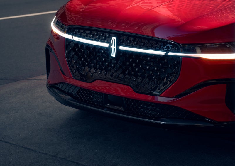 The available front LED light bar and center Lincoln Star logo glow at dusk. | Hooks Lincoln in Fort Worth TX