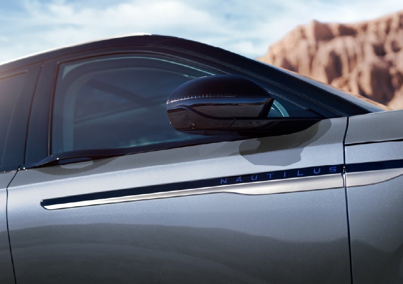 Blue lettering on the side of the vehicle that reads Nautilus indicates the available Hybrid Powertrain. | Hooks Lincoln in Fort Worth TX