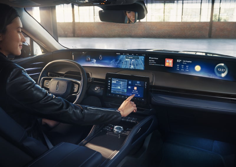The driver of a 2026 Lincoln Nautilus® SUV interacts with the center touchscreen. | Hooks Lincoln in Fort Worth TX