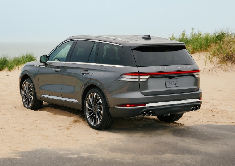 A 2027 Lincoln Aviator® SUV is parked next to sand dunes. | Hooks Lincoln in Fort Worth TX