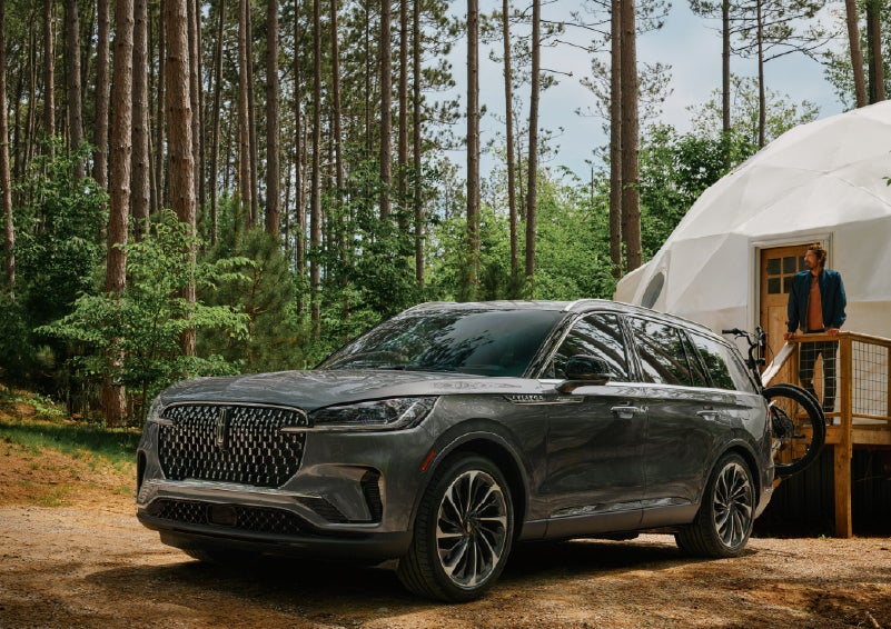 A 2027 Lincoln Aviator® is parked next to a high end glamping site. | Hooks Lincoln in Fort Worth TX