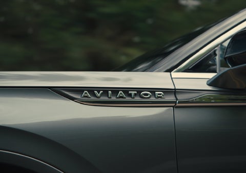 The driver’s side door and fender badging of a gray 2027 Lincoln Aviator® SUV are showcased. | Hooks Lincoln in Fort Worth TX
