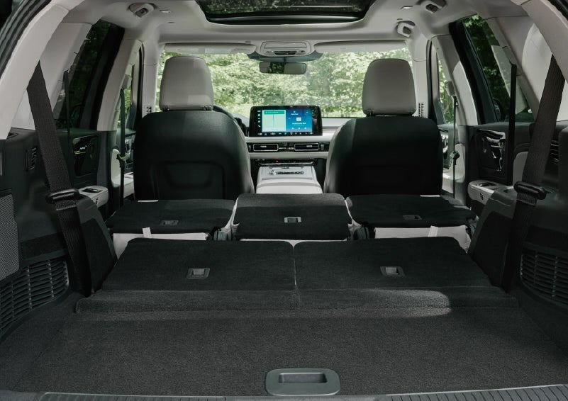 A rear to front view of the interior of a 2027 Lincoln Aviator® Black Label™ SUV shows the third and second rows folded flat | Hooks Lincoln in Fort Worth TX