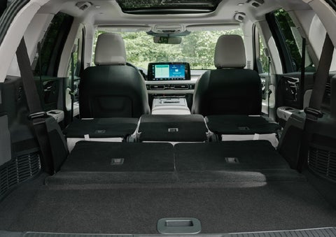 A rear to front view of the interior of a 2027 Lincoln Aviator® Black Label™ SUV shows the third and second rows folded flat | Hooks Lincoln in Fort Worth TX