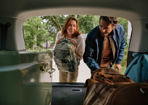 A couple loads luggage into the rear of a 2027 Lincoln Aviator® Black Label™ SUV..e 202 | Hooks Lincoln in Fort Worth TX