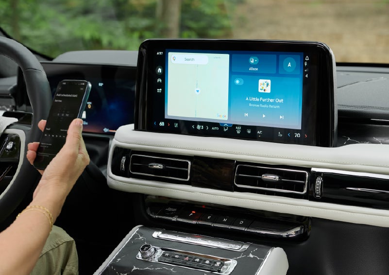 A person pairs thier phone with the center touchscreen of a 2027 Lincoln Aviator® Black Label™ SUV | Hooks Lincoln in Fort Worth TX