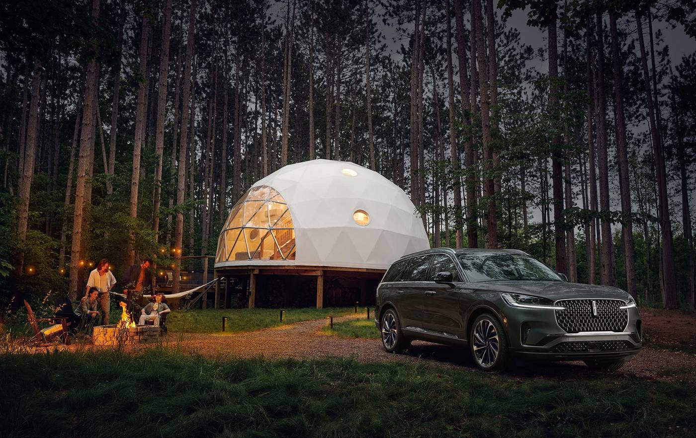 2027 Lincoln Aviator parked at a forest campsite at dusk for Fort Worth TX shoppers