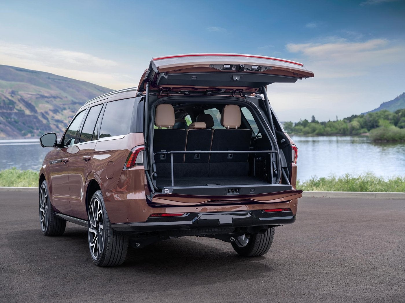 Copper Lincoln Navigator with the Split Gate open beside a lake for Fort Worth TX shoppers